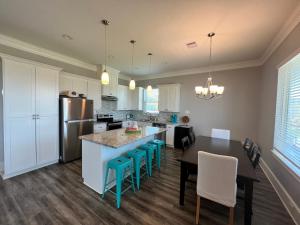 uma cozinha com uma mesa e cadeiras e um frigorífico em Sunny Catalina em Galveston