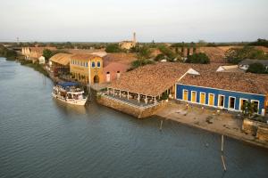 an aerial view of a river with houses and a boat at Pousada Beira Rio Parnaíba in Parnaíba