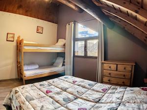 a bedroom with two bunk beds and a window at Chalet spacieux avec billard, proche des remontées mécaniques, idéal pour familles et cyclistes - FR-1-267-174 in Le Corbier