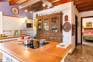 a kitchen with a stove and a counter top at Rural Village Salobre by VillaGranCanaria in Maspalomas