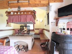 a kitchen with a stove and a fireplace at Holiday Home in Cison with Mountain Views in Cison di Valmarino