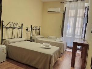 Postel nebo postele na pokoji v ubytování Arteaga Hostal & Baños Arabes Elvira