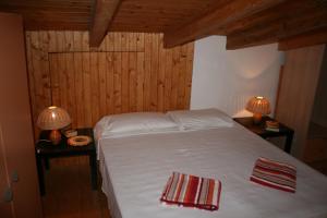 a bedroom with a white bed and two tables with lamps at Porto Antigo Three Bed Apartment with Sea View in Santa Maria