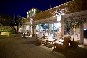 a patio with chairs and tables and a building at Hotel Osam - Adults Only in Supetar