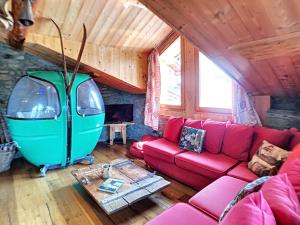 a living room with a couch and a table at Chalet en bois, 4 chambres, WIFI, skis, parking proche, 8 pers - FR-1-344-791 in Saint-Marcel