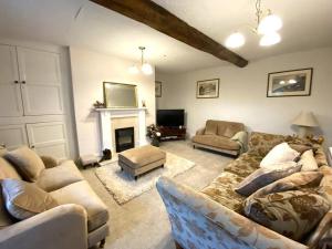 a living room with a couch and a fireplace at Farmhouse Cottage set in beautiful countryside in Oswestry