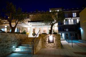 a building with a sign on the wall at night at Hotel Osam - Adults Only in Supetar