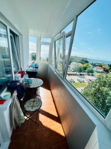 a room with two tables and large windows at By The Sea for Family in Mangalia