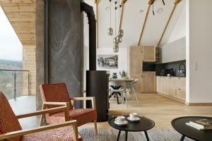 a kitchen and living room with a table and chairs at Korona Bieszczad in Wetlina