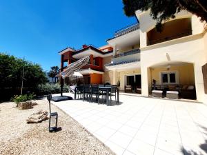 a patio of a house with a table and chairs at Bajo Amparo Altaona Golf in Murcia