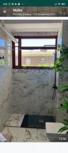 a bathroom with a window and a marble wall at Suites 5* Lahcene in Alicante