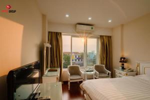 a hotel room with a bed and a window at White Hotel in Hà Tĩnh