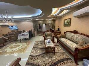 a living room with a couch and a table at شقة عائليه 701مطلة علي قناة السويس والبحر in Port Said