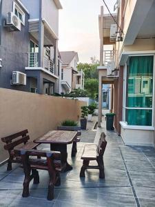 un patio avec des bancs et des tables dans un bâtiment dans l'établissement GUESTHOUSE #2 Semi Bungalow House, à Kuah