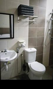 a bathroom with a white toilet and a sink at GUESTHOUSE #2 Semi Bungalow House in Kuah