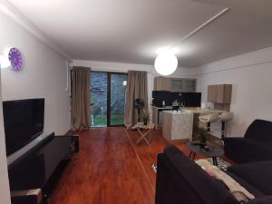 a living room with a couch and a table at Adorable Cozy Apartment in Aglantzia