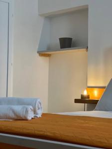a bedroom with a bed with towels on it at Masseria Piccole Taverne in Rosa Marina
