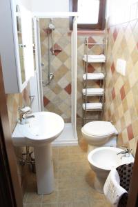 a bathroom with two sinks and a toilet and a shower at Casale Orioles in Torretta +37 photos