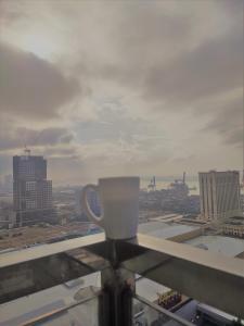 a coffee cup sitting on top of a window at Bay View Apartment Sunvida Tower 28 in Cebu City