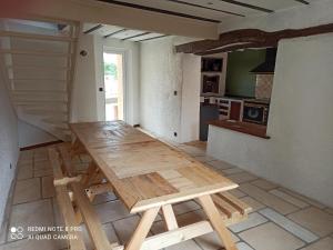 a wooden table in the middle of a kitchen at G1 les oliviers in Saint-Germain-de-Prinçay