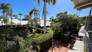 a large outdoor patio with palm trees and palm trees at Cable Beachside Villas in Broome