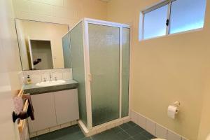 a bathroom with a sink, toilet and bathtub at Cable Beachside Villas in Broome