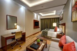 a hotel room with a bed and a desk at Rose Park Hotel - Al Barsha, Opposite Metro Station in Dubai