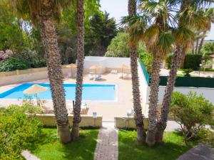 a resort with a swimming pool and palm trees at Vaia Residence in Torre dell'Orso