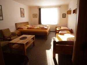 Sala de estar con 2 camas y mesa en Ubytování Lyžařská škola en Kubova Huť