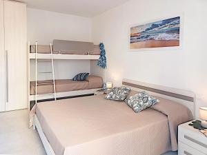 two beds in a room with two bunk beds at Residence Green Life in Bibione