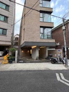a building with a motorcycle parked in front of it at Hao Guesthouse in Hongdae in Seoul