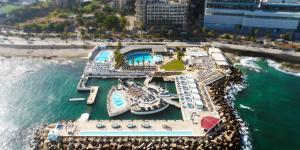 an aerial view of a marina with a cruise ship at Riviera Hotel and Beach Lounge, Beirut in Beirut