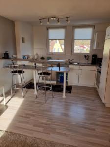 a kitchen with a table and chairs in a room at Ferienwohnung Söhreblick in Wattenbach