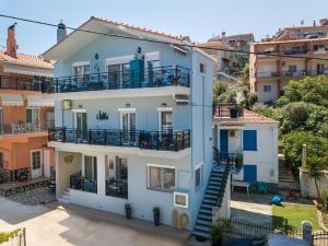 an apartment building with a blue facade and balconies at Ioanna Villa in Skala Marion
