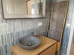 a bathroom with a stone sink on a wooden counter at Casa Rosalinda in Figari