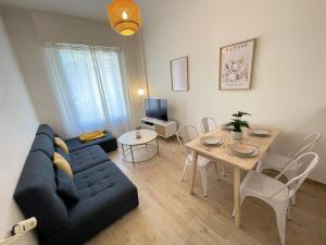 a living room with a blue couch and a table at Nice Renting - Penchienatti - Spacious Apartment - 2 BedRooms - King Bed - View Heart of Nice in Nice