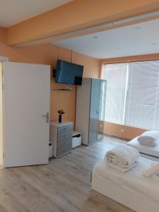 a bedroom with two beds and a flat screen tv at Gazi in Popovo