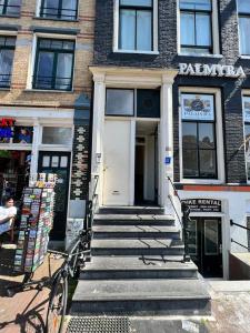 un edificio con escaleras que conducen a una puerta blanca en Central B&B Apartment in Amsterdam, en Ámsterdam