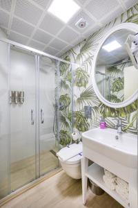 a bathroom with a shower and a toilet and a sink at Princess Kinli Suites Hotel in Marmaris