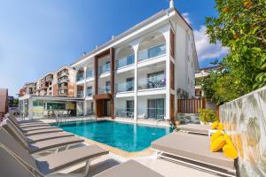 an apartment with a swimming pool in a building at Princess Kinli Suites Hotel in Marmaris
