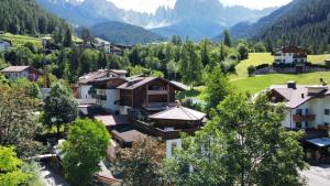 a village in the mountains with houses and trees at Schneiderhaus in Bagni di Lavina Bianca