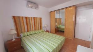 a bedroom with a bed and a sliding glass door at VILLA PANORAMA El Mediterráneo a tus pies. in Salobreña