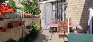 a patio with two tables and chairs and a fence at Apartment Alena with terrace and garden Center Jelsa in Jelsa