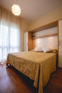 Una cama o camas en una habitación de Hotel Loretta & Dependance
