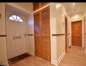 a hallway with a white door and a window at Isla Way Stays in Keith +75 photos