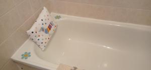 a white bath tub with a pillow sitting on it at Isla Way Stays in Keith