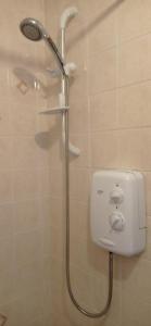 a shower with a shower head in a bathroom at Isla Way Stays in Keith
