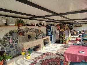 a living room with a table and a kitchen with a counter at Villa Savovi in Varna City