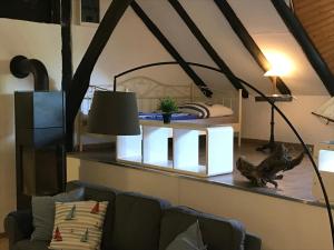a living room with a couch and a lamp at Gut Strackholt FeWo Seemannsgarn in Großefehn 