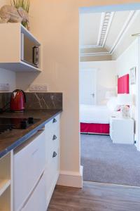 A kitchen or kitchenette at The Merryburn - Rooms and Courtyard Studios